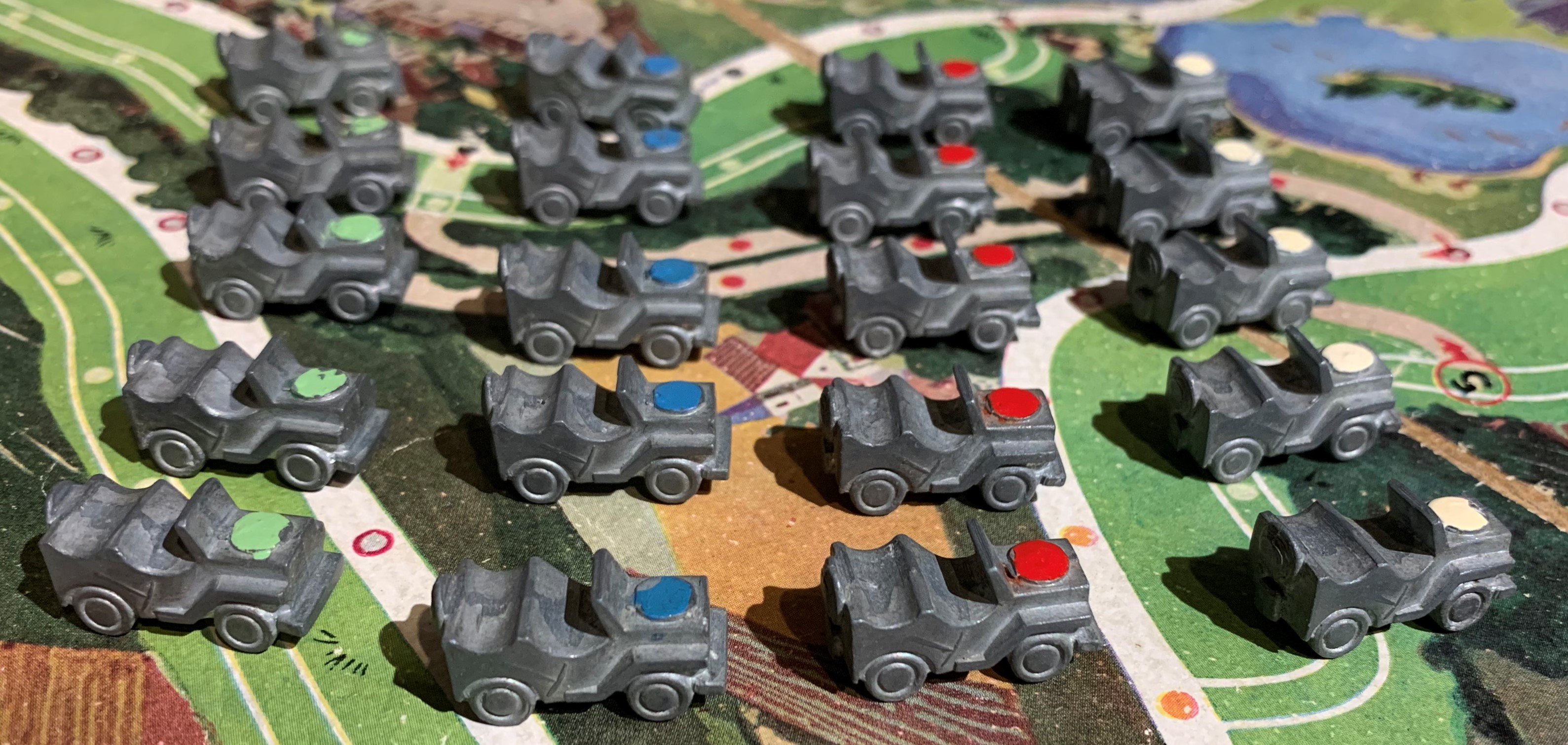 Playing pieces from Les Convois showing military jeeps
