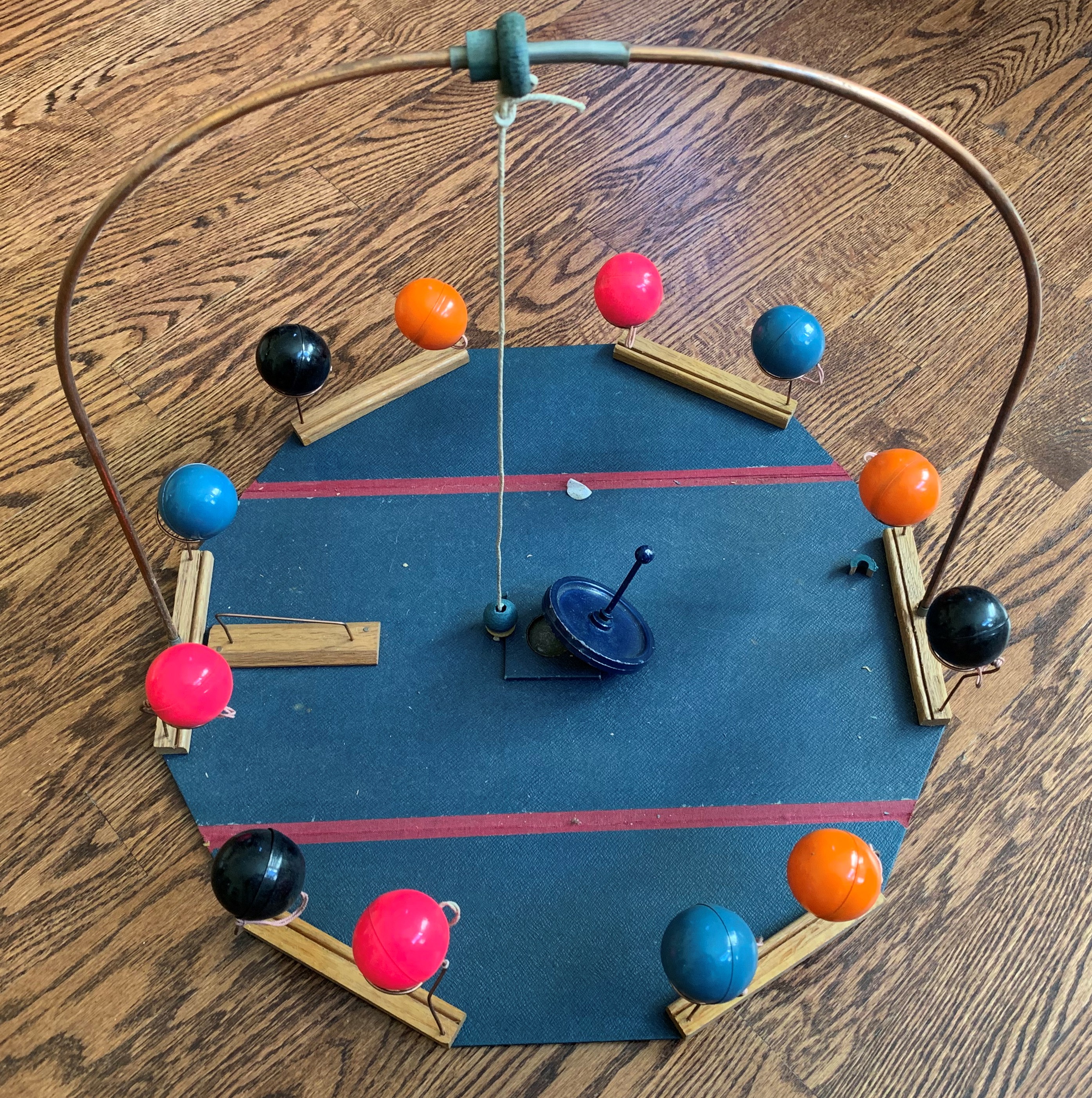 Bombardo dexterity game set up with spinning top and colored balls